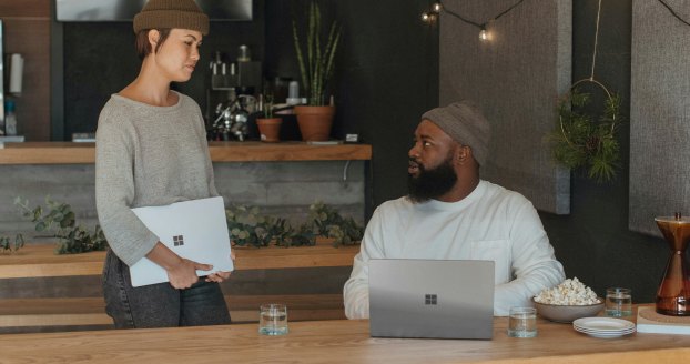 Two colleagues discussing a project across a cafe table